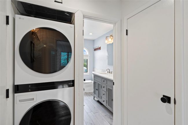 Bedroom with wood finished floors, baseboard heating, and a ceiling fan | Image 26