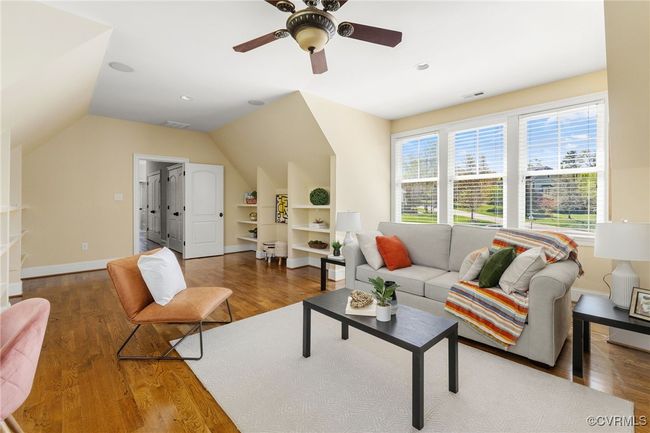 Site finished hard wood floors, surround sound, recessed lighting, ceiling fan with light, built in shelving. | Image 30