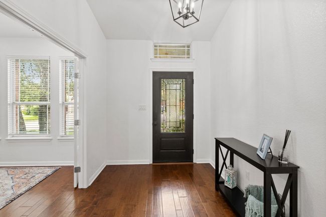 Entrance foyer with hardwood / wood-style floors and a chandelier | Image 5