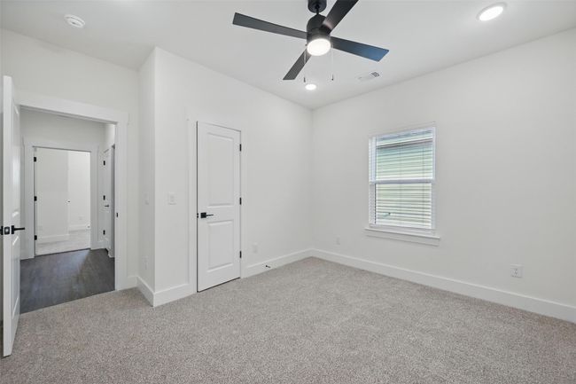 Unfurnished bedroom featuring carpet, a ceiling fan, baseboards, visible vents, and recessed lighting | Image 17