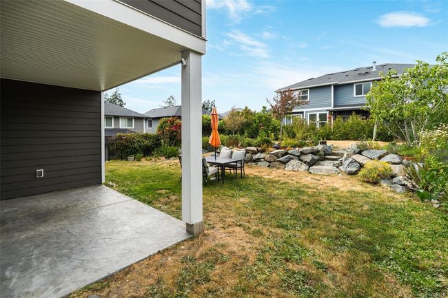 View of grassy yard with a patio area | Image 24
