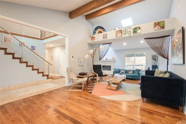 Stairs, living area, family room with windows looking out to porch!! Beautiful open spaces great for entertaining! | Image 26