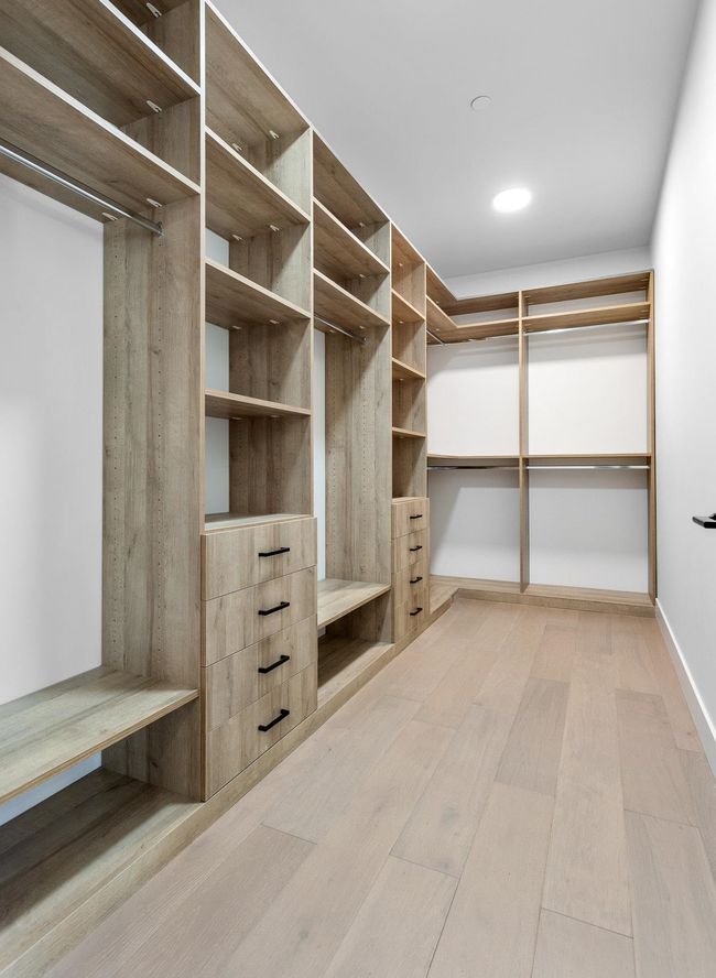 Walk in closet with wood finished floors | Image 17
