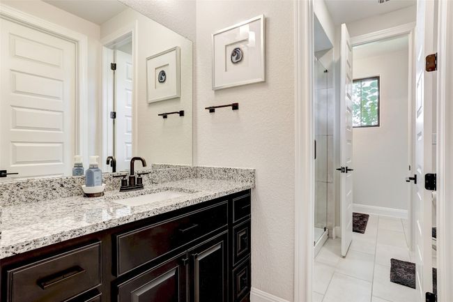 Bathroom featuring vanity, a stall shower, and tile patterned floors | Image 25