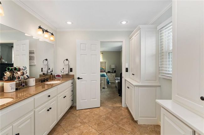 Bathroom featuring crown molding, plenty of natural light, vanity, and tile patterned floors | Image 31