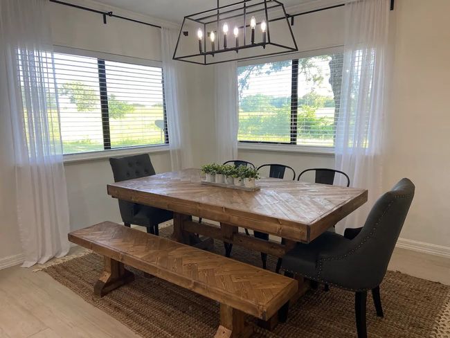 Dining area featuring light wood-type flooring and an inviting chandelier | Image 10