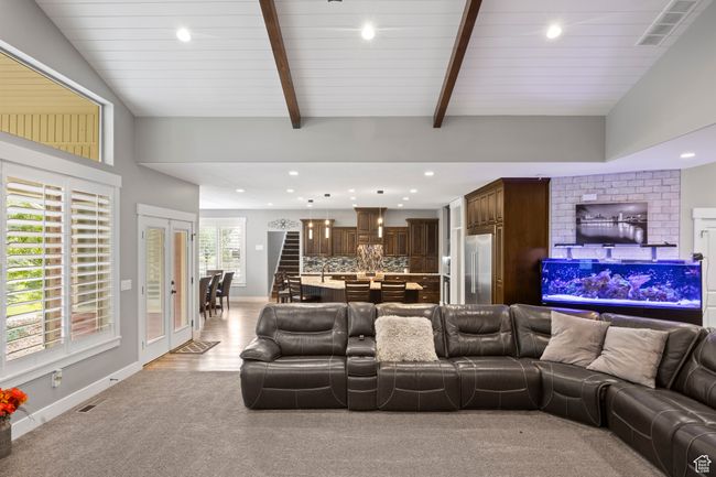 Living room with recessed lighting, baseboards, beam ceiling, and light colored carpet | Image 18