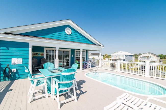 View of pool with a deck and outdoor dining area | Image 5