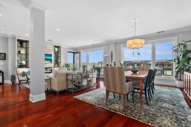 Kitchen with tasteful backsplash, a sink, a peninsula, ornamental molding, and stainless steel appliances | Image 5