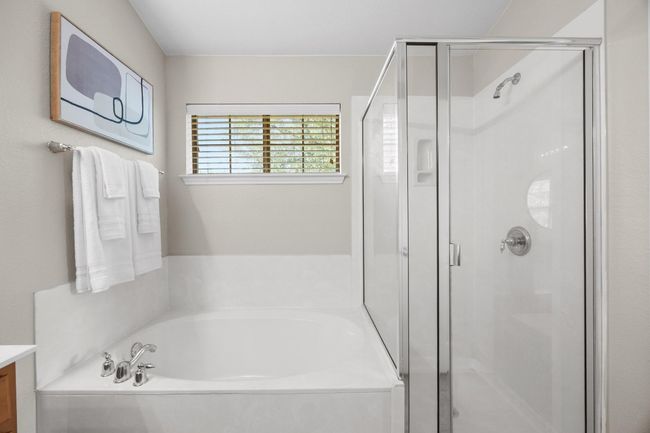 Bathroom featuring a garden tub, and separate shower | Image 26