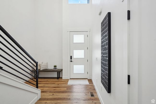 Foyer entrance with visible vents, stairs, and a wealth of natural light | Image 13