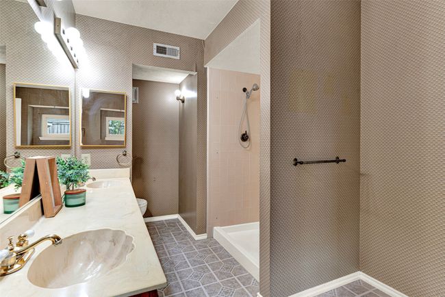 Full bath with double vanity, tiled shower, and tile patterned flooring | Image 18