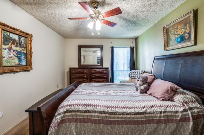 Bedroom featuring a textured ceiling and ceiling fan | Image 19
