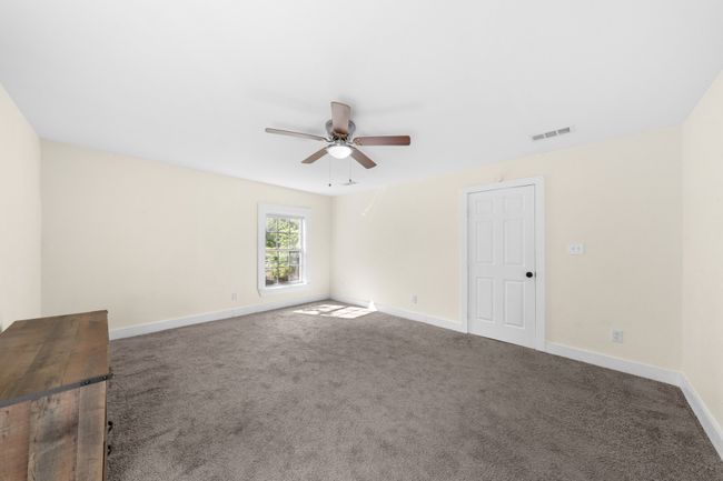 Carpeted spare room featuring a ceiling fan and baseboards | Image 14