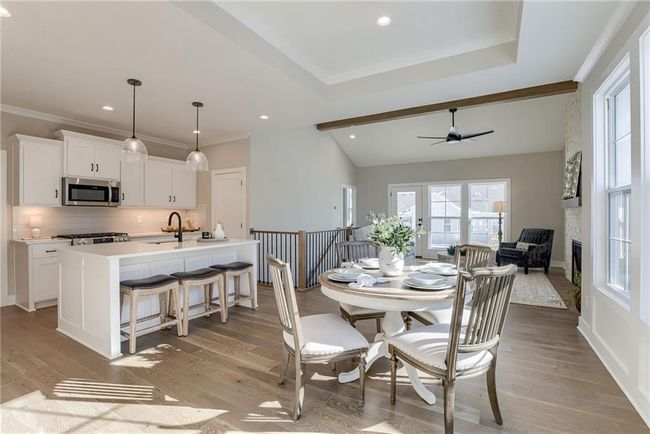 Dining area with light wood-style flooring, ceiling fan, and plenty of natural light | Image 6