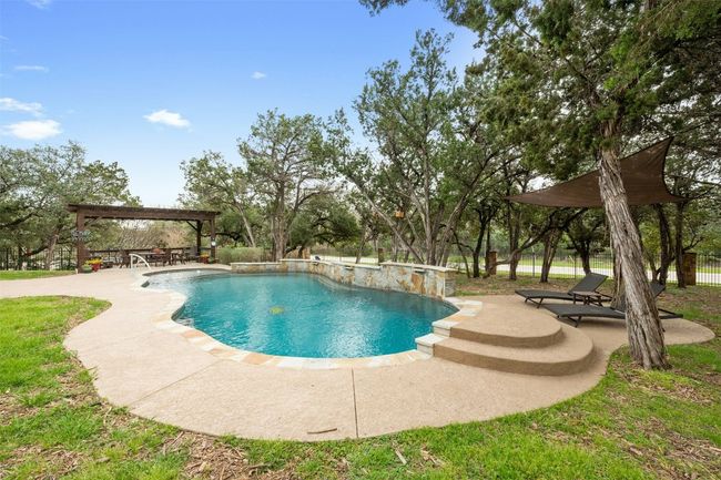 Beyond the pool is a seating area perfect for fire pit to roast smores! | Image 37
