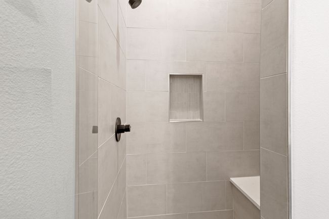 Bathroom featuring a tile shower | Image 18