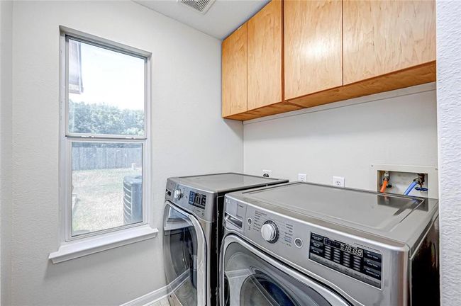 The utility room is tucked behind the kitchen for easy access. Washer and dryer are included. | Image 20