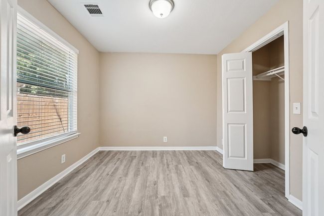 Unfurnished bedroom featuring light wood finished floors and baseboards | Image 20