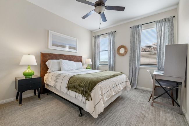 Bedroom featuring baseboards, light carpet, and a ceiling fan | Image 21