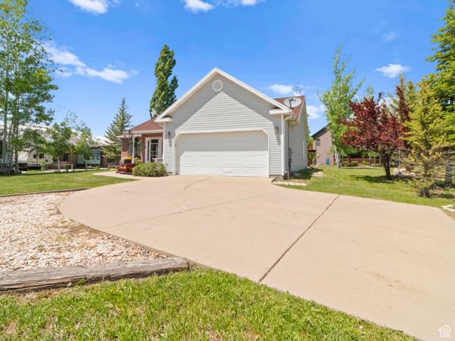 View of front facade with a garage, a front yard, and concrete driveway | Image 28
