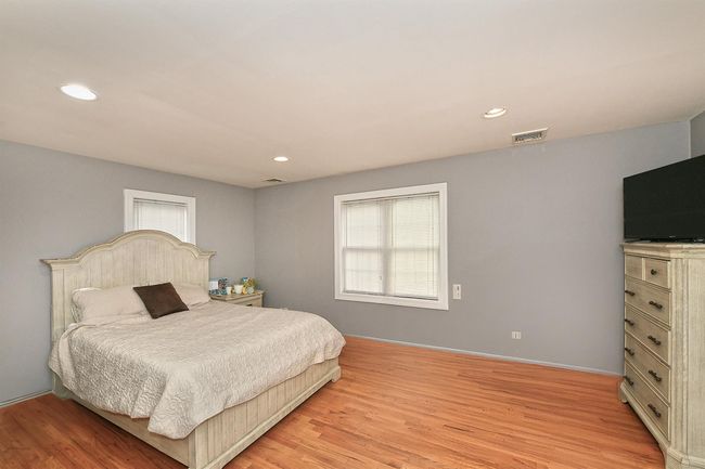 Bedroom with visible vents, light wood finished floors, and recessed lighting | Image 19