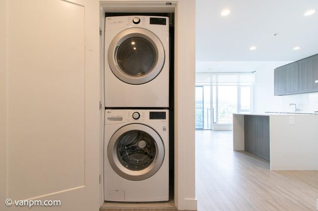 Laundry room featuring estacked washer and dryer, recessed lighting, and light wood-style floors | Image 12