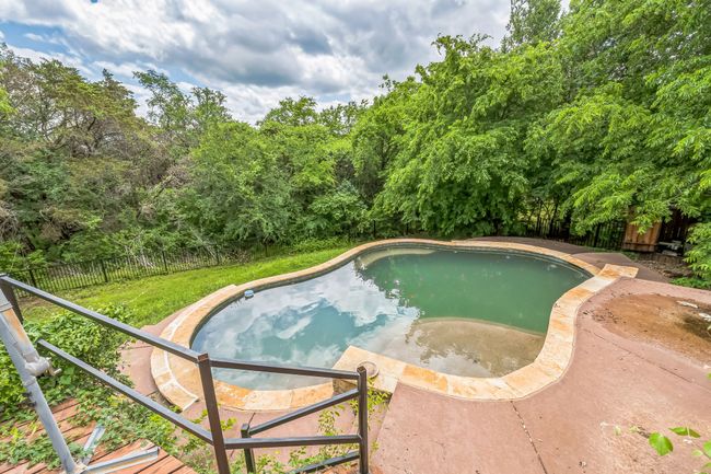 View of pool featuring a fenced in pool, a lawn, and a fenced backyard | Image 4