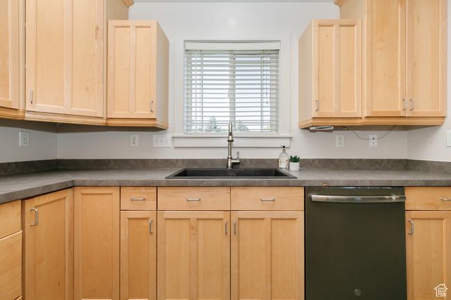 Kitchen featuring dishwasher, light brown cabinetry, and dark countertops | Image 9