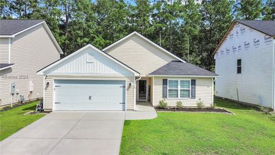 View of front of home featuring a garage and a front lawn | Image 2