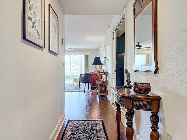 Entering the foyer you'll see all the way through main living spaces and out to golf course and pond | Image 14