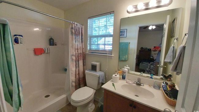 Bathroom with vanity and a shower with shower curtain | Image 8