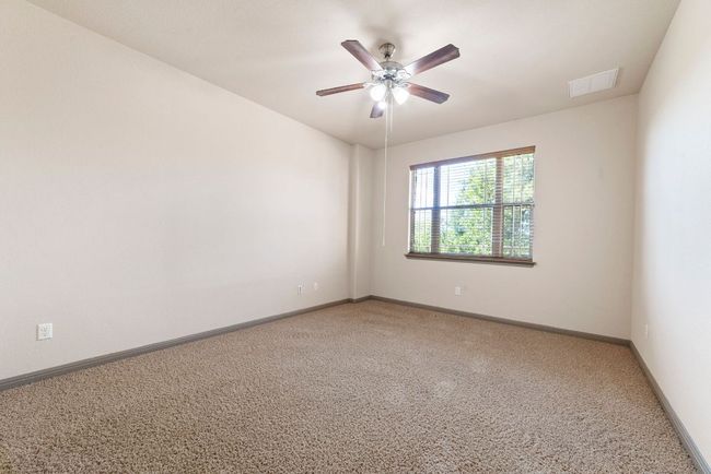 Empty room featuring light carpet and a ceiling fan | Image 36