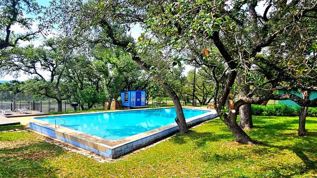 Community pool with a lawn and fence | Image 21