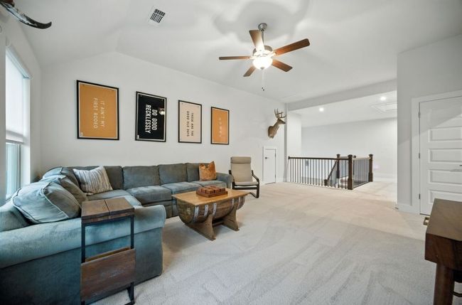 Upstairs Carpeted Family room featuring a ceiling fan and vaulted ceiling | Image 27
