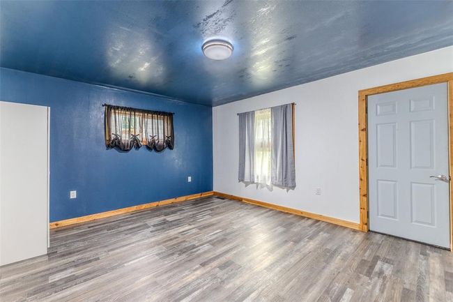 Unfurnished room with wood finished floors and baseboards | Image 25