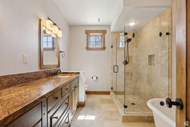 Full bathroom featuring a shower stall, a wealth of natural light, and vanity | Image 18