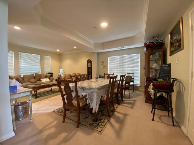 Carpeted dining room with a tray ceiling and ornamental molding | Image 19
