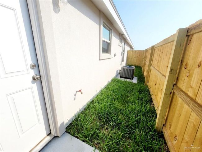 View of property exterior featuring stucco siding and a fenced backyard | Image 20