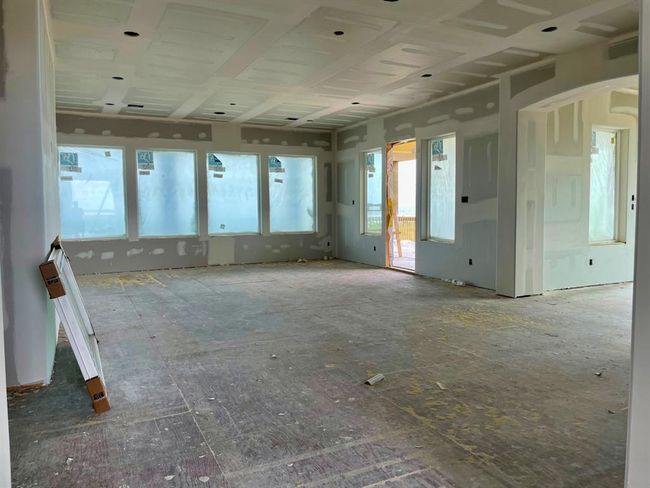 Inside the great room at sheetrock stage — massive windows frame wide-open Gulf views, flooding the main living space with natural light. Imagine hosting gatherings here with ocean breezes just steps away. A prime canvas for luxury design and an unforgettable guest experience. | Image 27