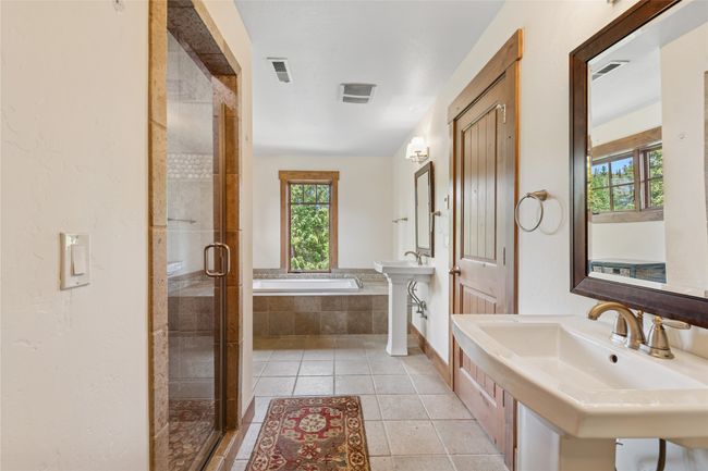 Primary bathroom featuring plenty of natural light, a bath, tile patterned flooring, and a shower stall | Image 37