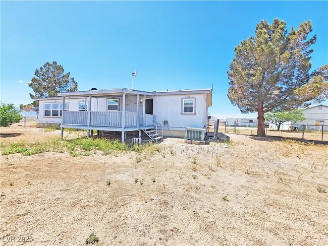 Rear view of property featuring central air condition unit and fence | Image 31