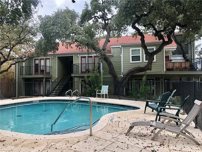 Community pool with stairs and a patio area | Image 10