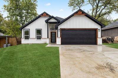 Modern farmhouse featuring a garage and a front yard | Image 1