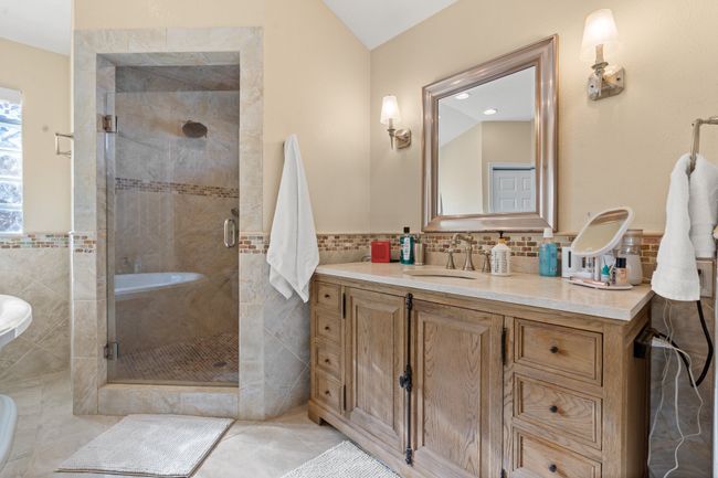 Primary Bathroom featuring vanity, a LARGE shower, and tile walls | Image 28