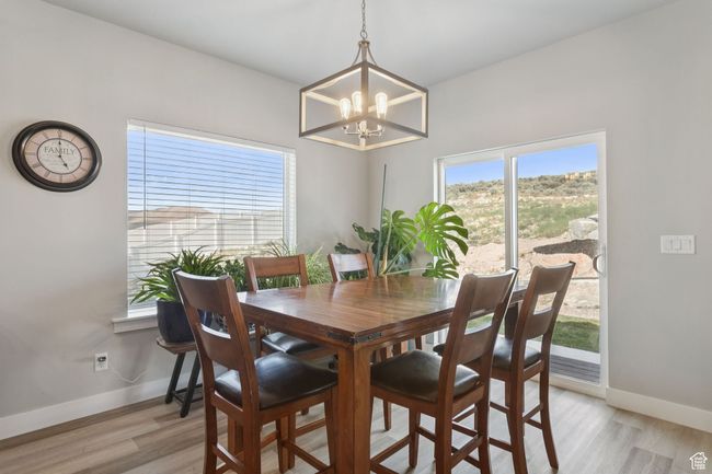 Dining space with a chandelier, healthy amount of natural light, and light wood-style floors | Image 17