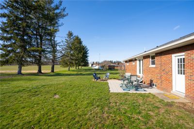 Awesome back yard on this all level lot with space between neighbors and a field behind you! | Image 2