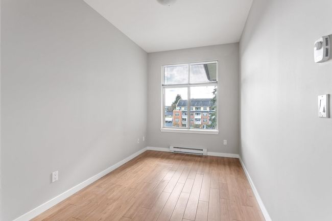 Empty room with baseboards, light wood finished floors, and a baseboard radiator | Image 25
