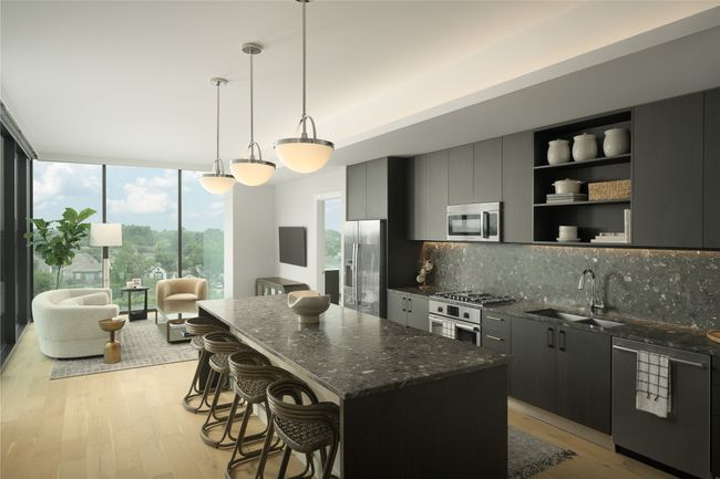 Kitchen featuring stainless steel appliances, decorative backsplash, light wood-type flooring, a center island, and a wall of windows | Image 4