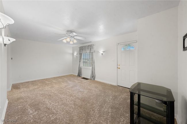 Carpeted spare room with ceiling fan | Image 8